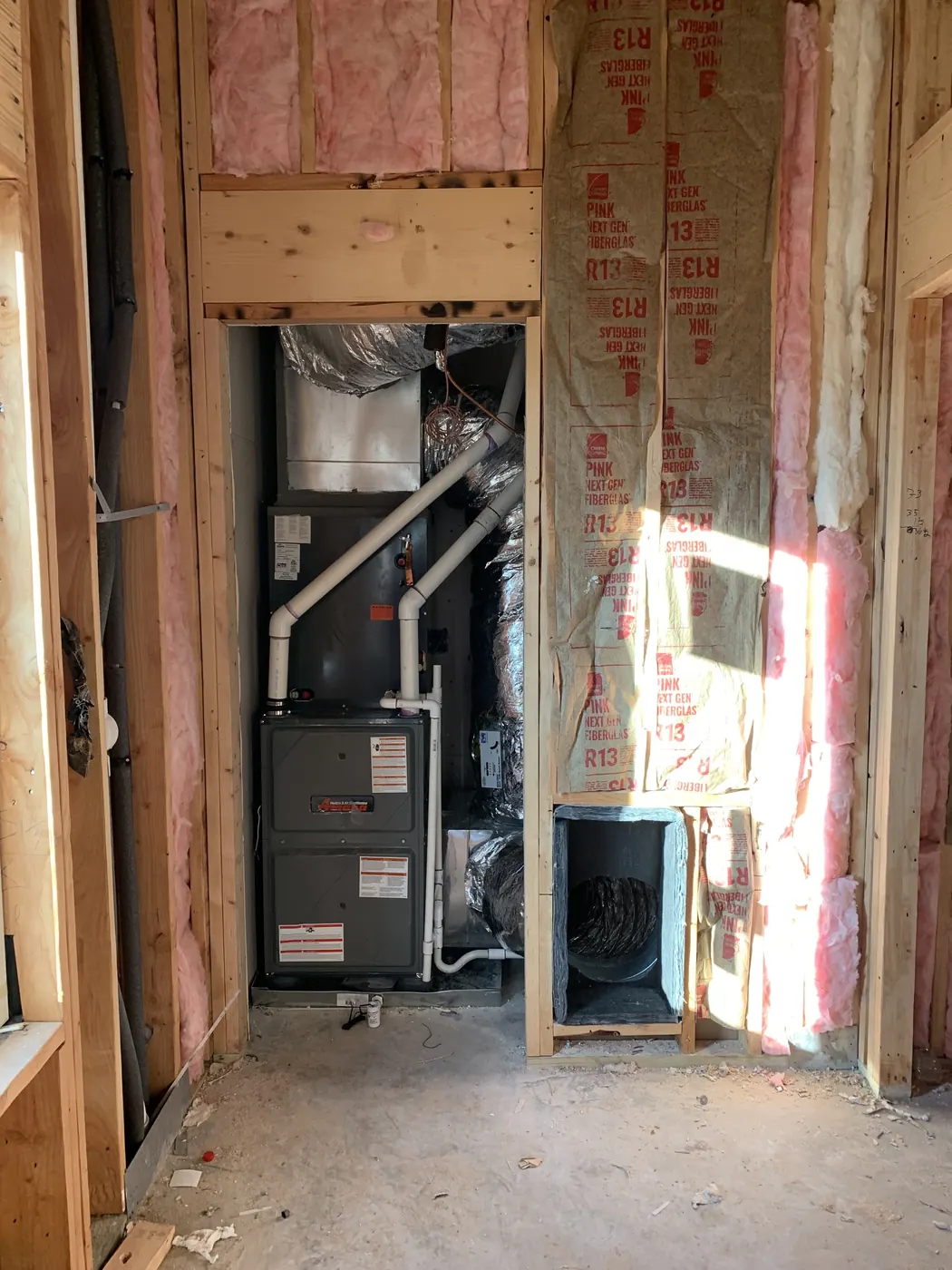 A furnace and air handler installed in a home under construction