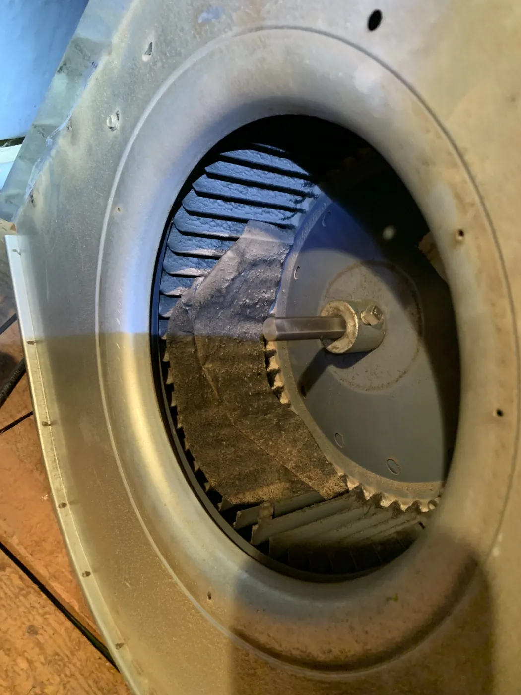 A blower wheel removed for cleaning during HVAC maintenance
